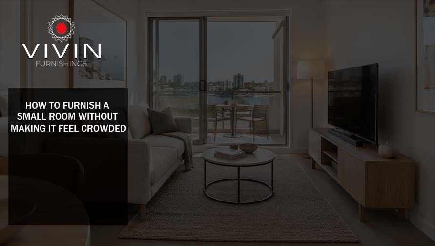 Small modern living room furnished with a neutral sofa, TV unit, coffee table and large window